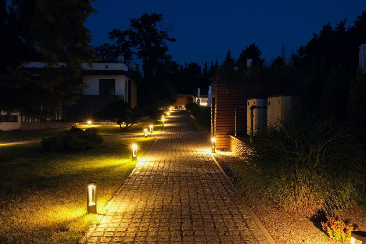 Stone path in a country residence illuminated by landscape lamps